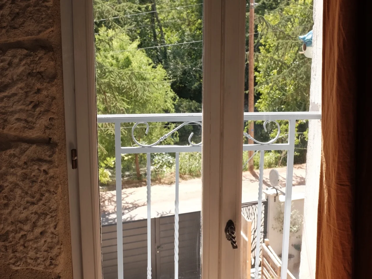 French casement window opening onto greenery