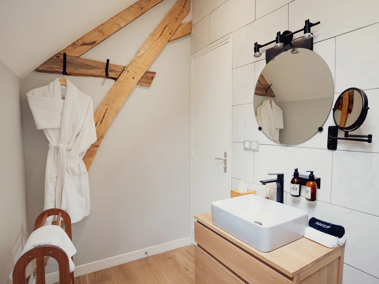 Bathroom vanity with marble tile and bathrobe