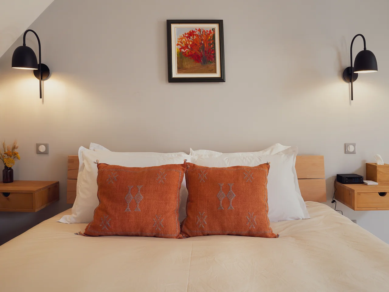 Bedroom with stone accent wall and terracotta pillows