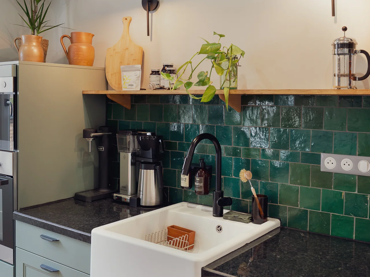 Sage green kitchen with emerald tile backsplash